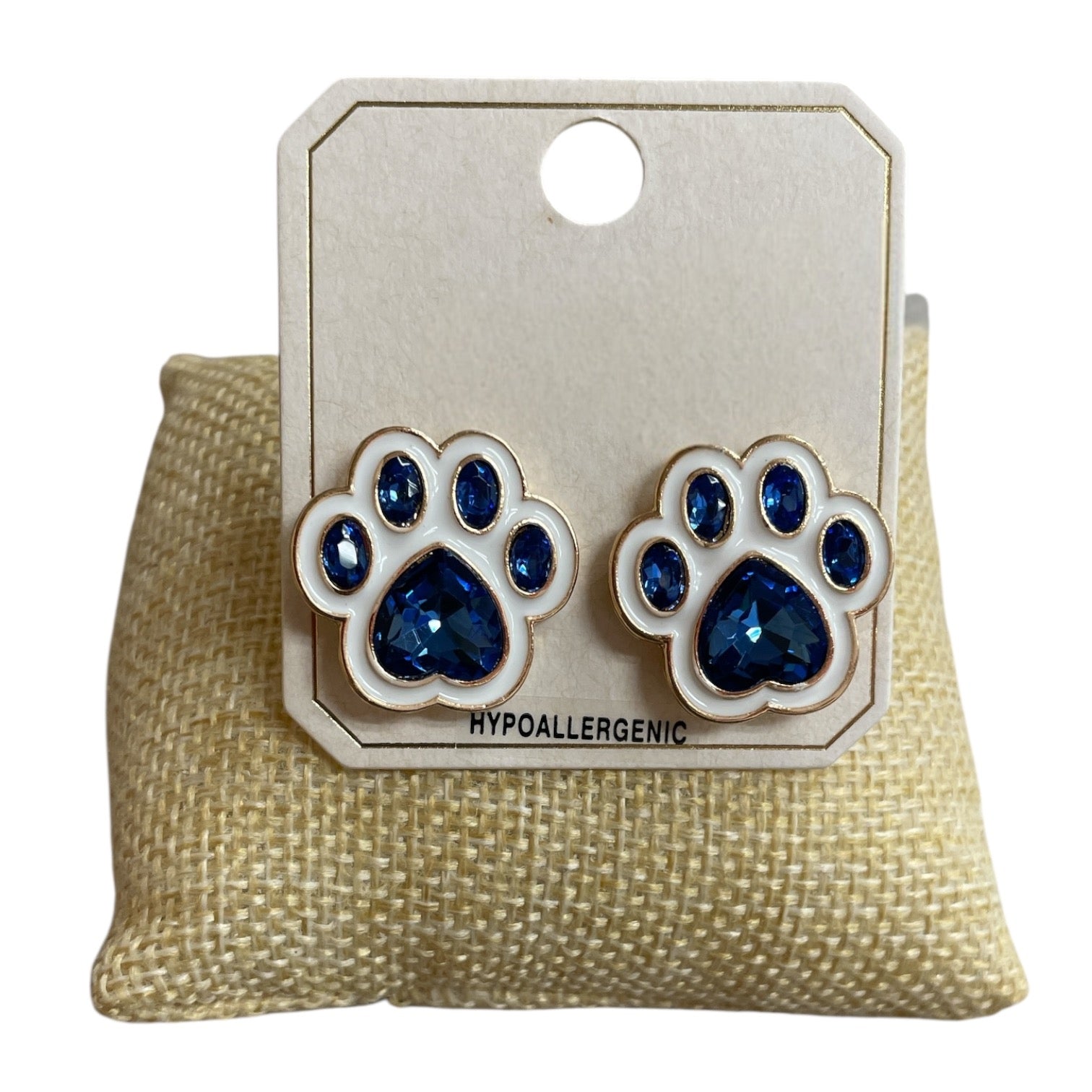 All That Glitterz blue paw print stud earrings featuring sparkling blue rhinestones, white enamel accents, and gold-tone trim.