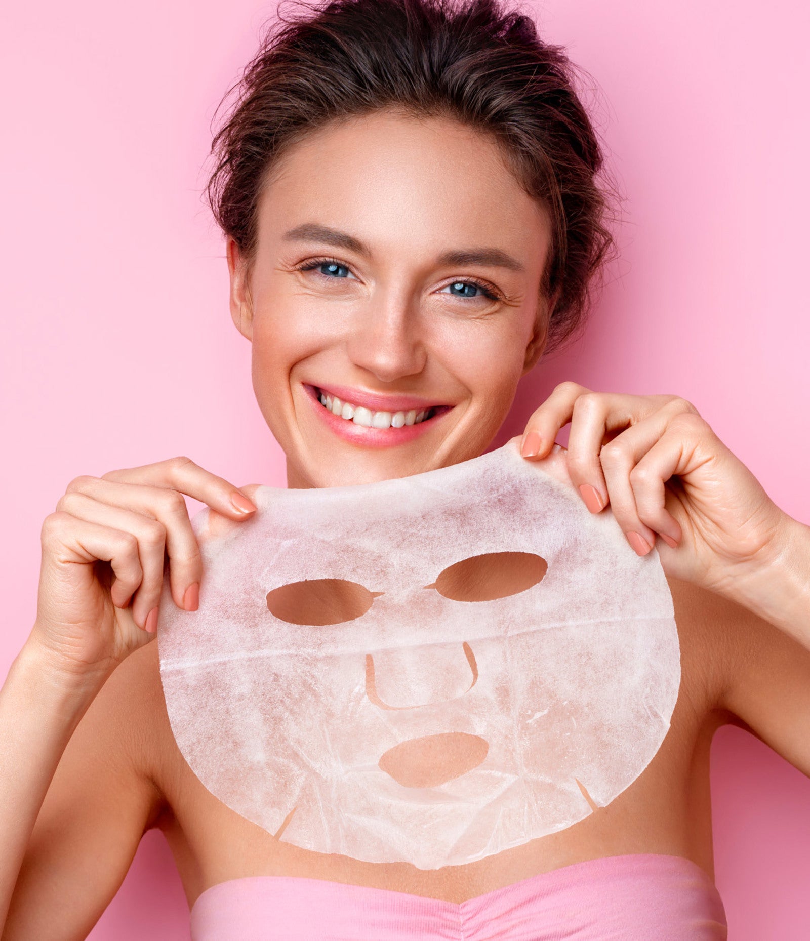 Model holding Lemon Lavender® Sheet Dreams Korean skincare face mask during a spa routine.